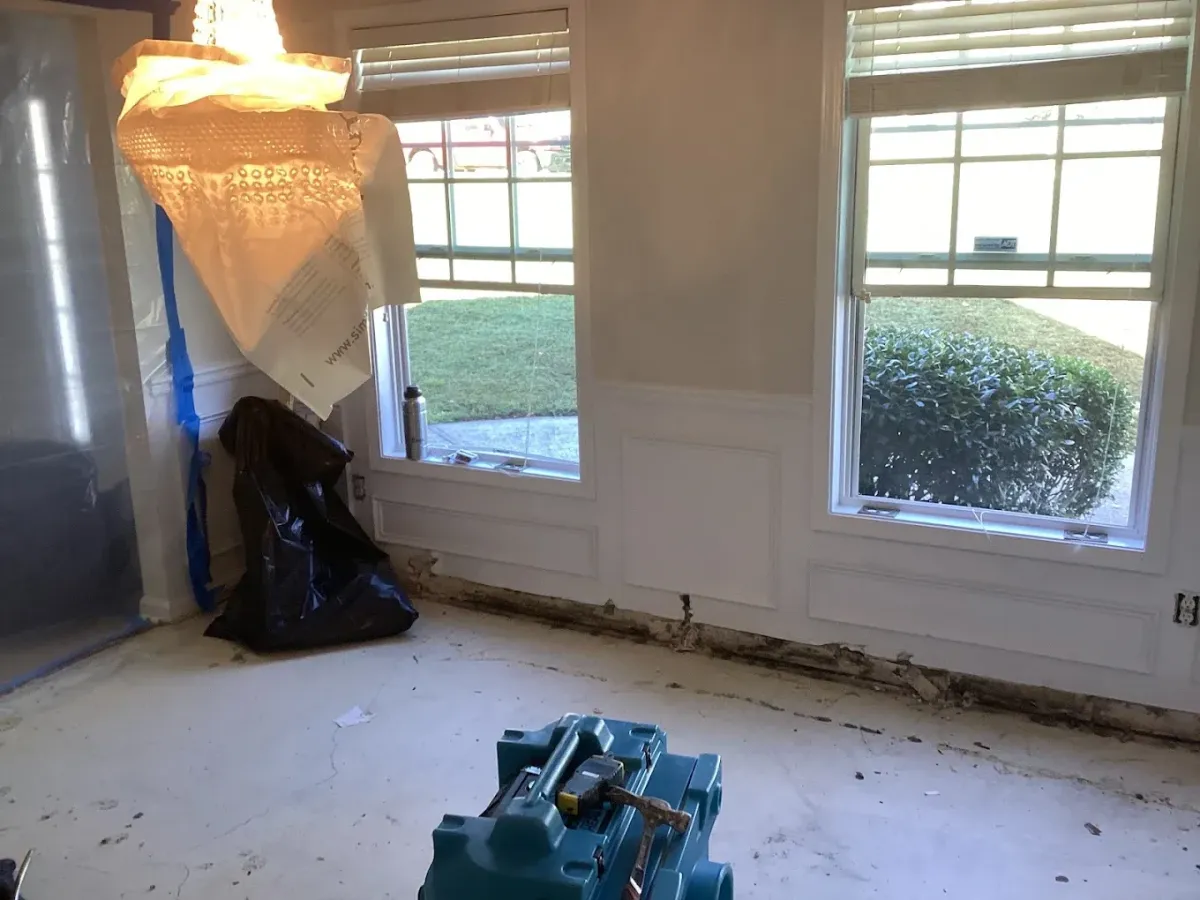 Technician cleaning smoke-damaged walls to remove odor after a house fire
